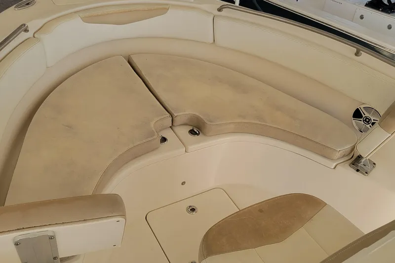 Slide: The Image of 2018 Robalo R222 Center Console boat interior with cushioned seating and storage compartments. - 9