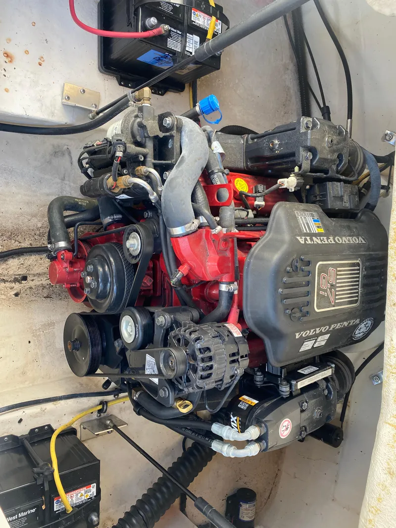 Slide: The Image of 2006 Chaparral Sunesta 252 engine compartment with Volvo Penta motor and battery setup. - 10