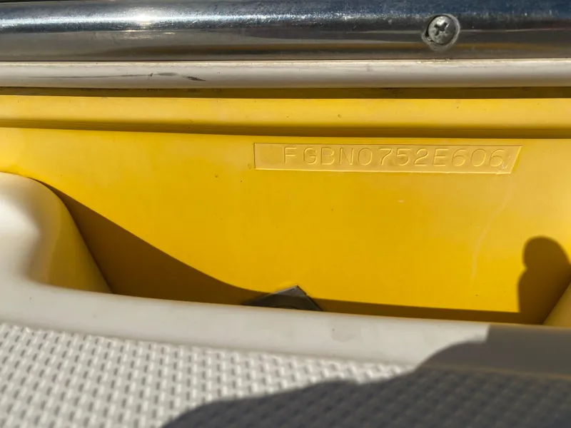 Slide: The Image of 2006 Chaparral Sunesta 252 boat hull identification number on yellow surface. - 11