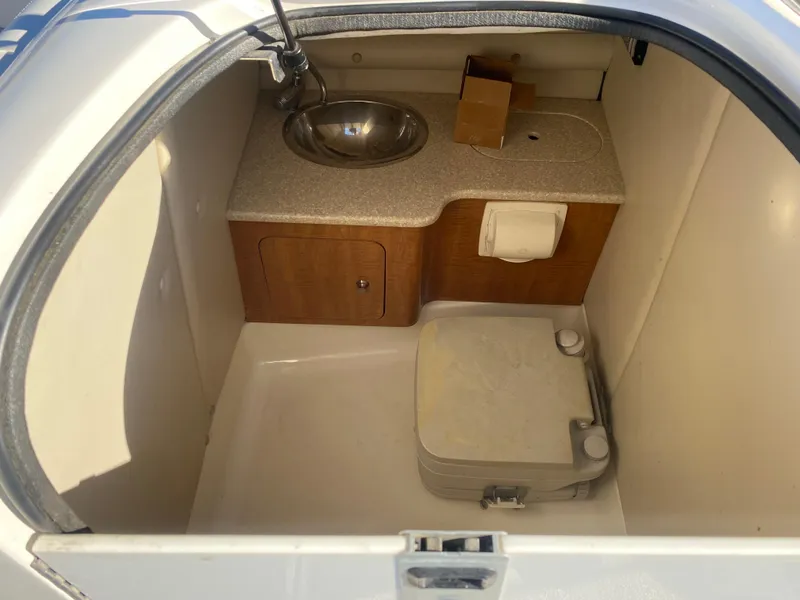 Slide: The Image of 2006 Chaparral Sunesta 252 boat interior with sink and storage area. - 7