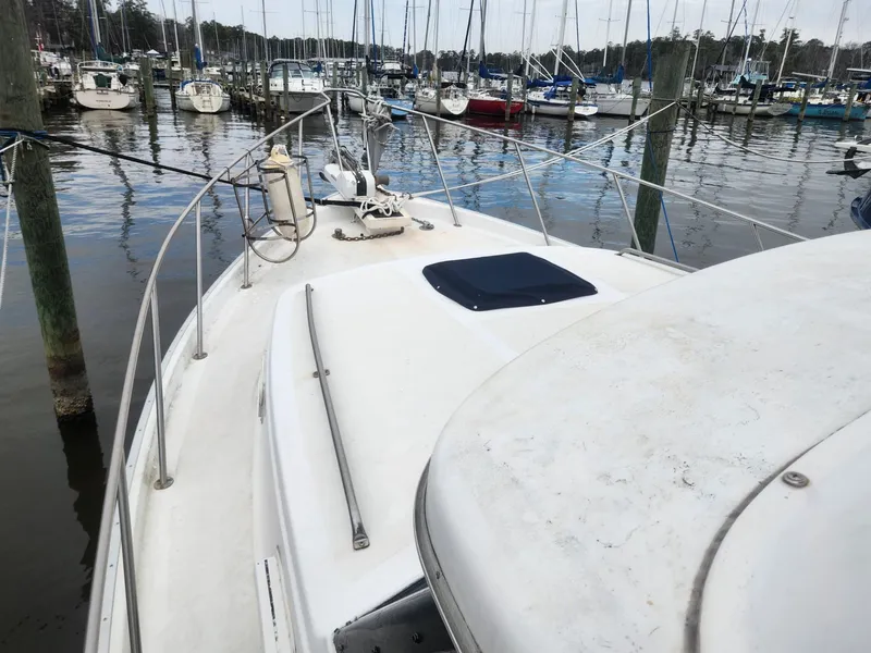 Slide: The Image of 1981 Mainship 34 Trawler docked in a marina with other boats. - 10