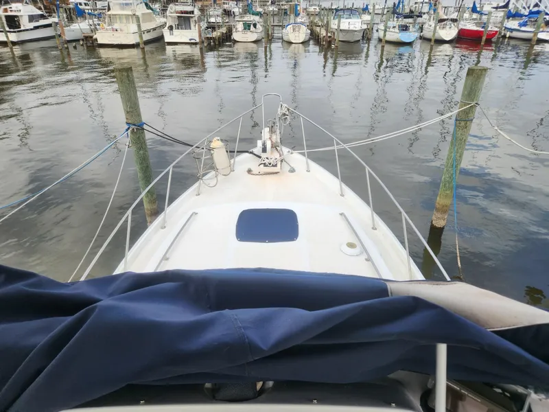 Slide: The Image of 1981 Mainship 34 Trawler docked at marina, view from bow. - 13