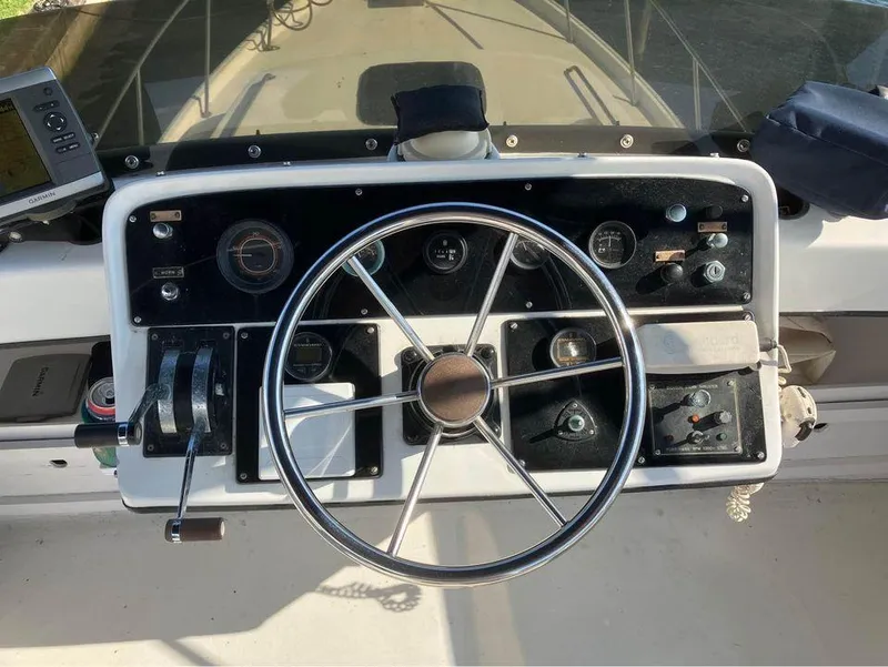 Slide: The Image of 1981 Mainship 34 Trawler helm with steering wheel and control panel. - 14