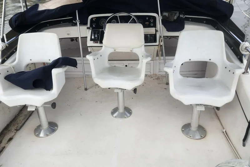 Slide: The Image of 1981 Mainship 34 Trawler helm with three white captain chairs. - 16