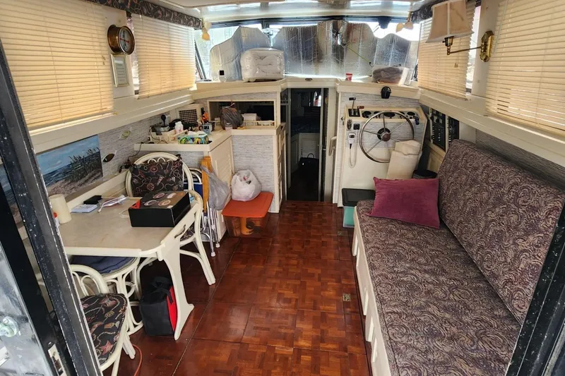 Slide: The Image of Interior of 1981 Mainship 34 Trawler with cozy seating and nautical decor. - 22