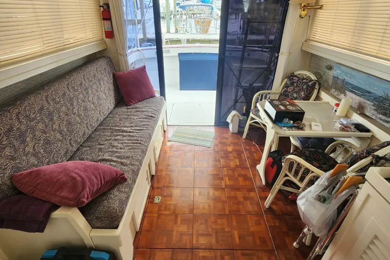 Slide: The Image of Interior of 1981 Mainship 34 Trawler with cozy seating and dining area. - 23