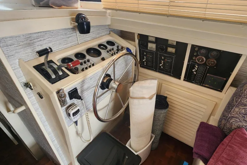 Slide: The Image of 1981 Mainship 34 Trawler helm with steering wheel and control panel. - 24