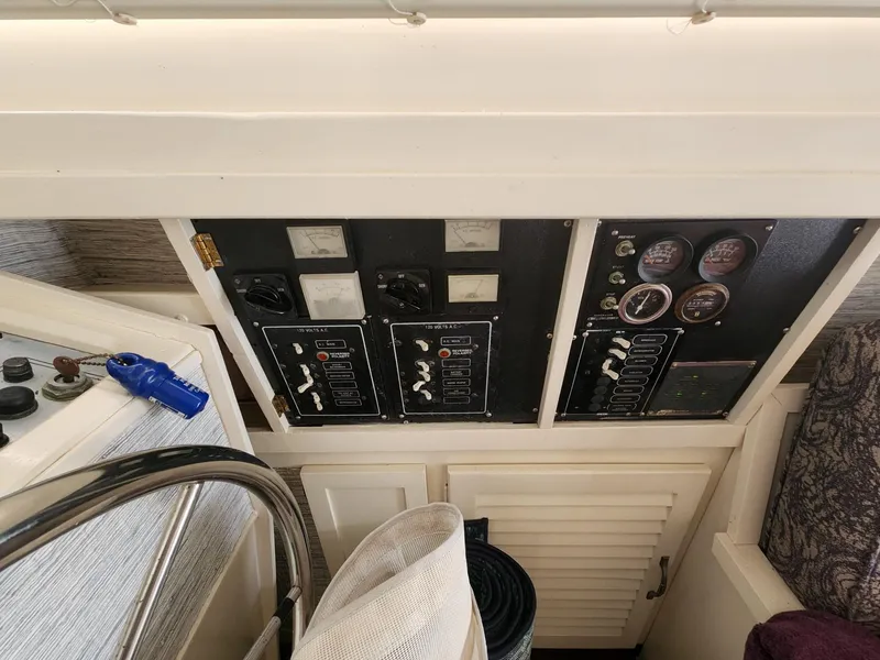 Slide: The Image of Control panel of a 1981 Mainship 34 Trawler, featuring gauges and switches. - 27