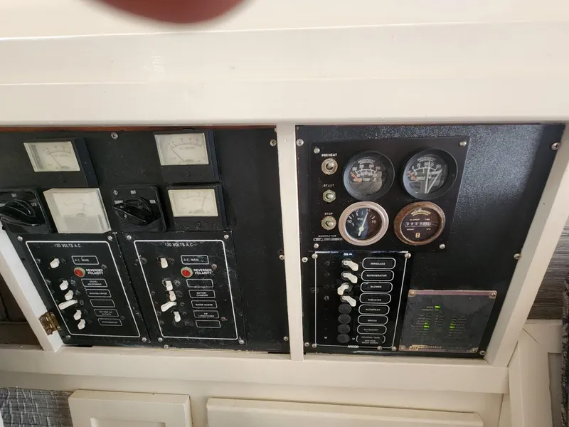 Slide: The Image of Control panel of a 1981 Mainship 34 Trawler with gauges and switches. - 28