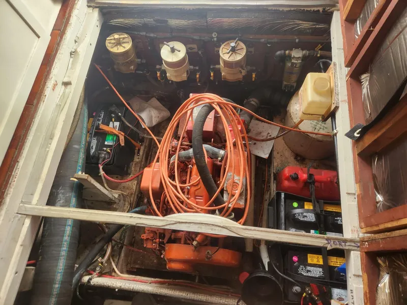 Slide: The Image of Engine room of a 1981 Mainship 34 Trawler with visible components and wiring. - 39