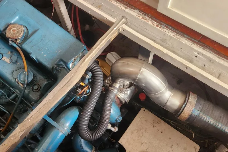 Slide: The Image of Engine compartment of a 1981 Mainship 34 Trawler, showcasing mechanical components. - 40