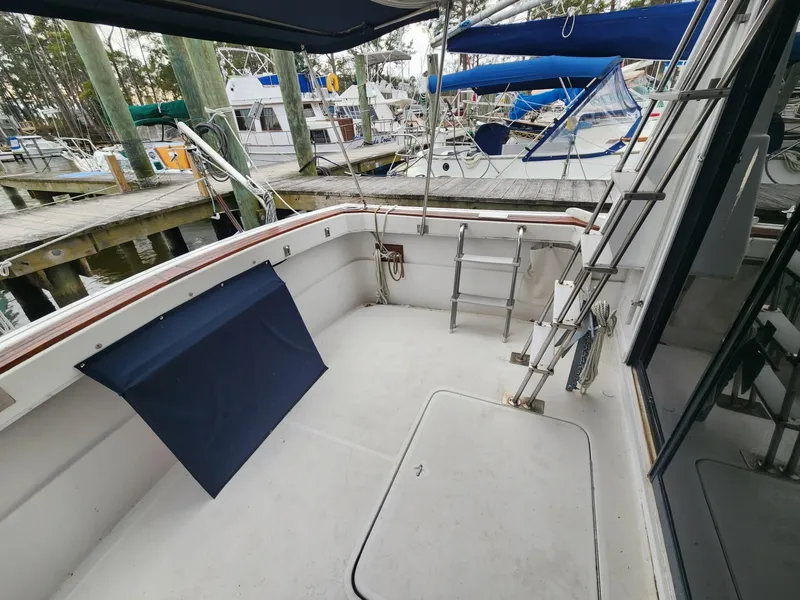 Slide: The Image of 1981 Mainship 34 Trawler deck with ladder, docked at marina. - 8