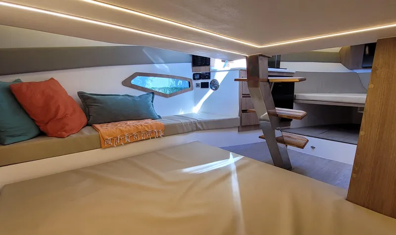Slide: The Image of 2023 NX Boats NX340 cabin interior with modern design and cozy seating area. - 22