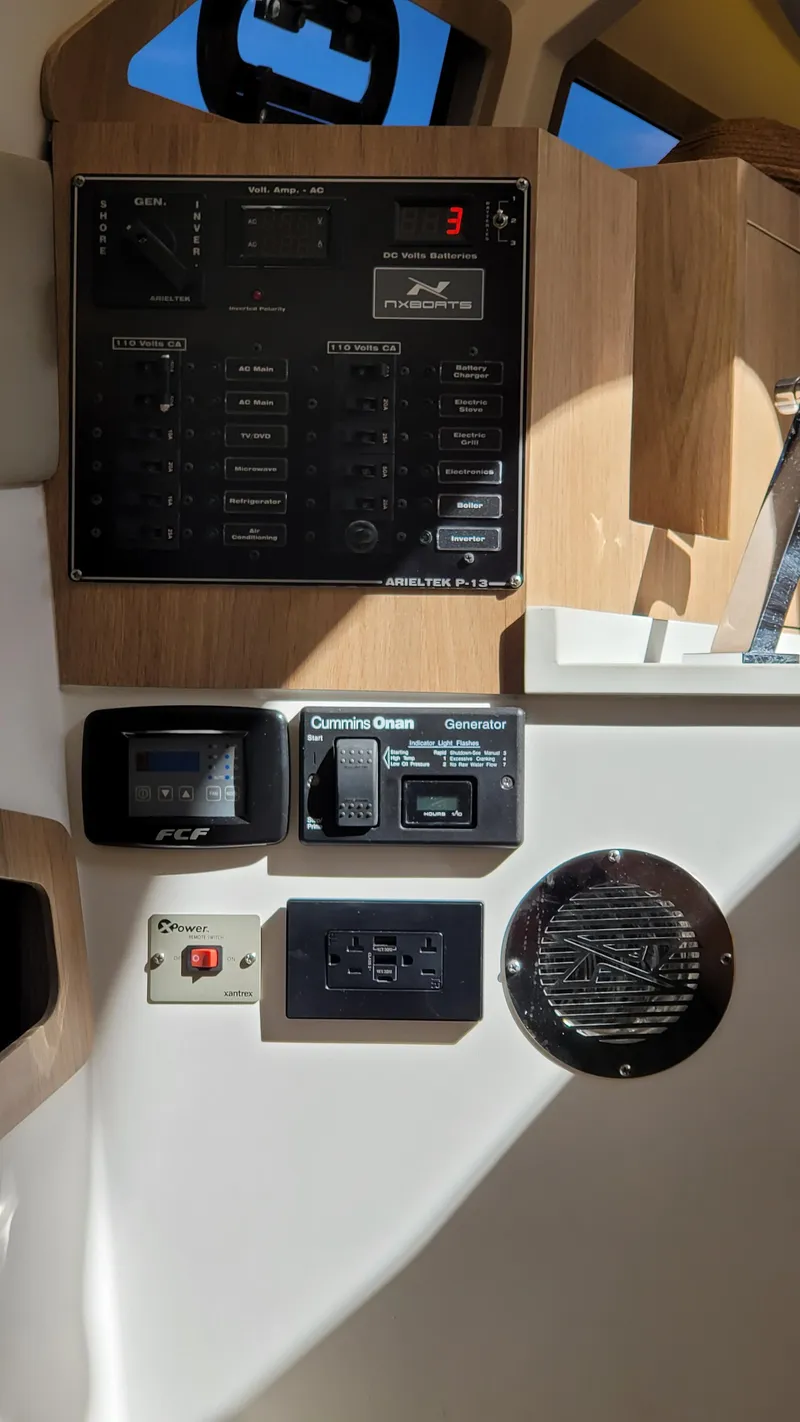 Slide: The Image of Control panel of 2023 NX Boats NX340, featuring various switches and gauges. - 26