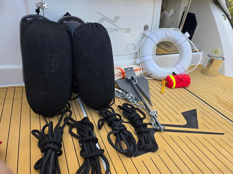 Slide: The Image of 2023 NX Boats NX340 deck with fenders, ropes, anchor, and lifebuoy. - 27