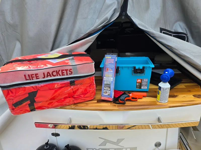 Slide: The Image of 2023 NX Boats NX340 with safety gear: life jackets, toolbox, air horn, and accessories. - 28