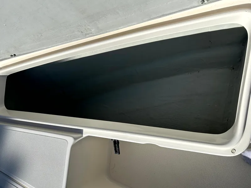 Slide: The Image of Storage compartment of a 2003 Pursuit 2470 Center Console boat, open and empty. - 10
