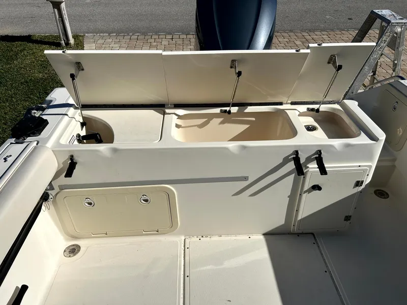 Slide: The Image of 2003 Pursuit 2470 Center Console boat interior with open storage compartments. - 17