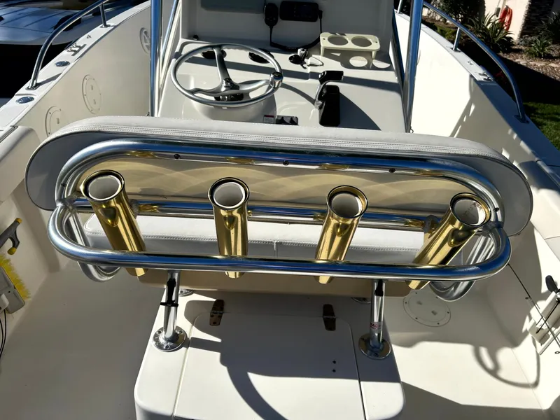 Slide: The Image of 2003 Pursuit 2470 Center Console boat interior with rod holders and steering wheel. - 25