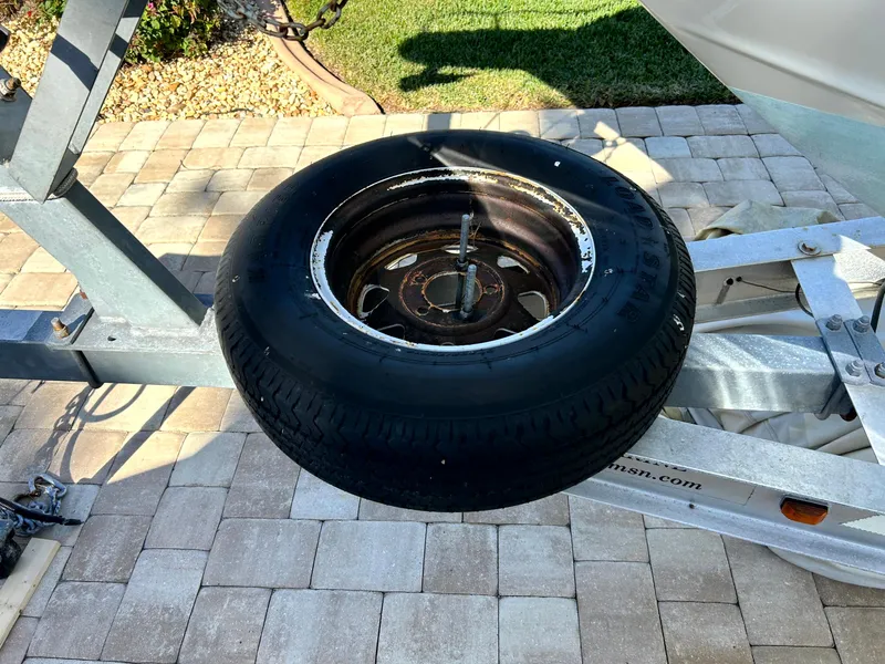 Slide: The Image of Spare tire mounted on a boat trailer for a 2003 Pursuit 2470 Center Console. - 30