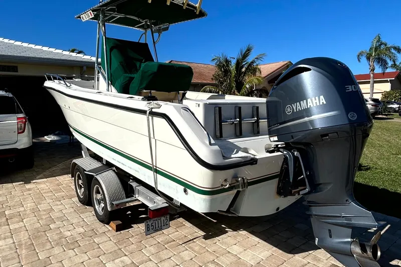 Slide: The Image of 2003 Pursuit 2470 Center Console boat with Yamaha engine on trailer. - 34