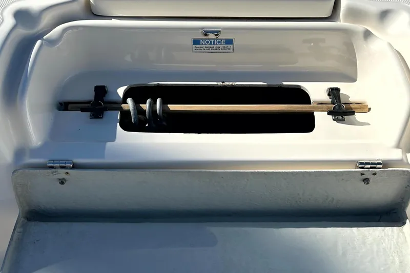 Slide: The Image of 2003 Pursuit 2470 Center Console storage compartment with rod holder. - 35