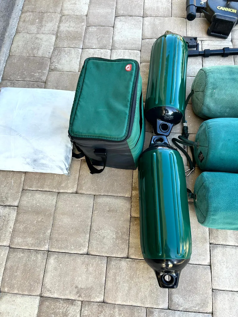 Slide: The Image of Green boat fenders and gear on a tiled surface, related to a 2003 Pursuit 2470 Center Console. - 7