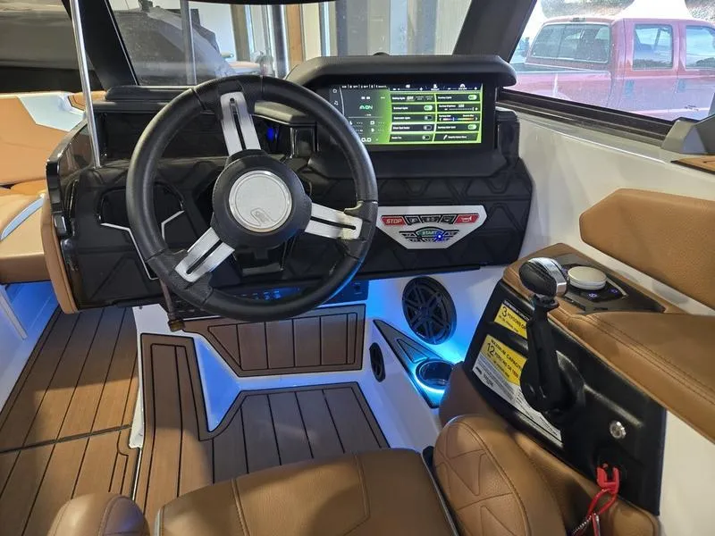 Slide: The Image of 2023 Nautique Super Air Nautique GS20 interior with modern dashboard and steering wheel. - 12