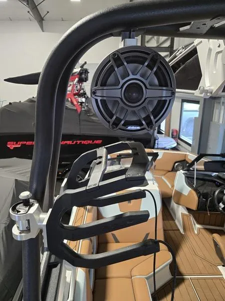 Slide: The Image of 2023 Nautique Super Air Nautique GS20 interior with speaker and wakeboard rack. - 15