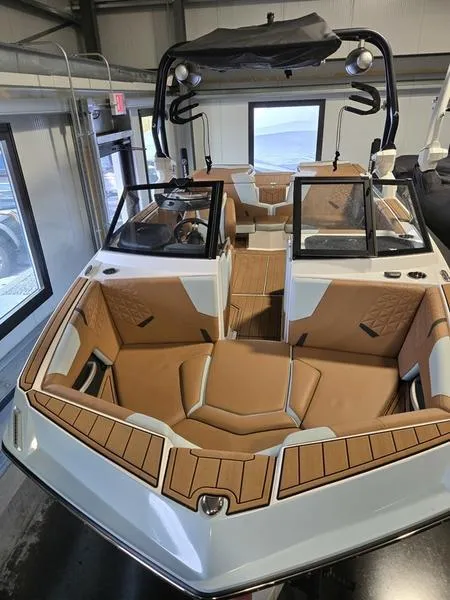 Slide: The Image of 2023 Nautique Super Air Nautique GS20 boat with tan interior in showroom. - 17