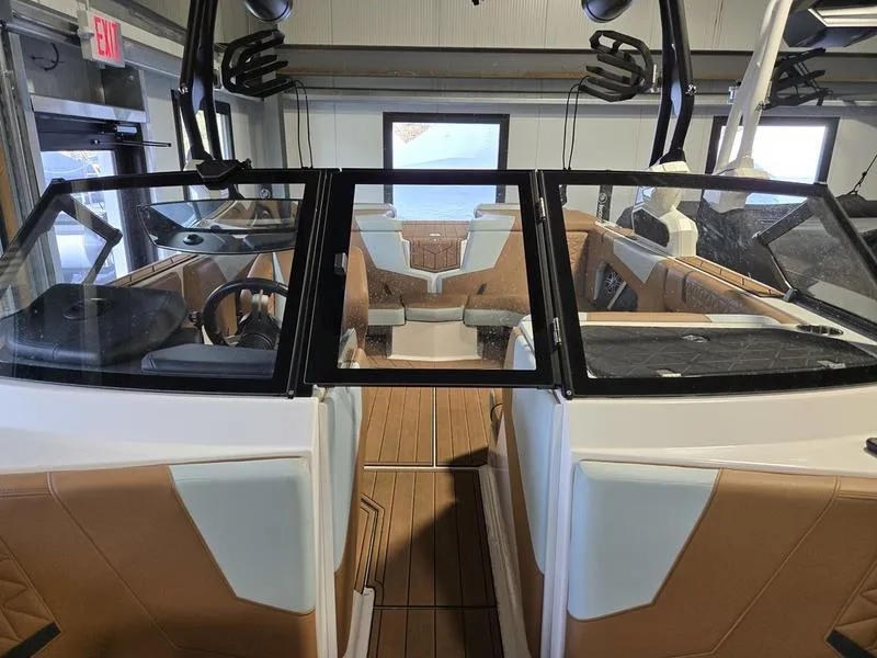Slide: The Image of 2023 Nautique Super Air Nautique GS20 interior with tan and white seating, modern design. - 18