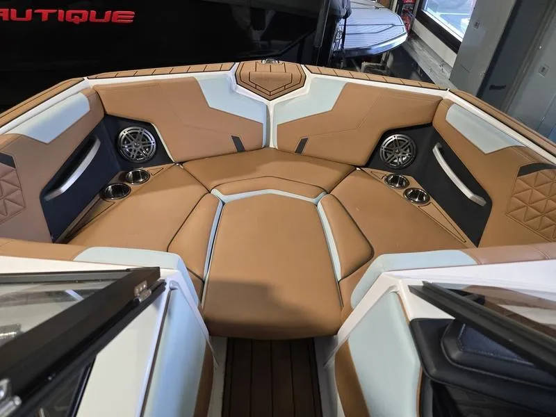 Slide: The Image of 2023 Nautique Super Air Nautique GS20 interior with tan seating and built-in speakers. - 20