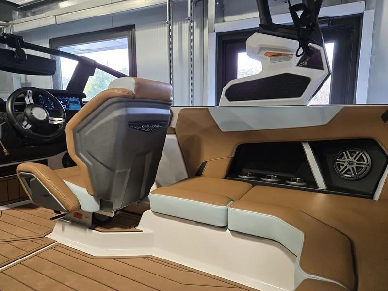 Slide: The Image of 2023 Nautique Super Air Nautique GS20 interior with tan and white seating, modern dashboard. - 21