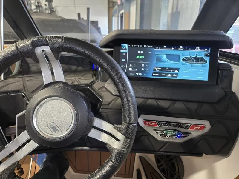 Slide: The Image of 2023 Nautique Super Air Nautique GS20 dashboard with steering wheel and digital display. - 22