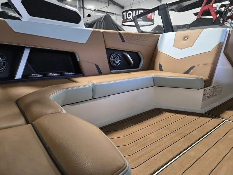 Slide: The Image of 2023 Nautique Super Air Nautique GS20 interior with tan seating and wood flooring. - 23