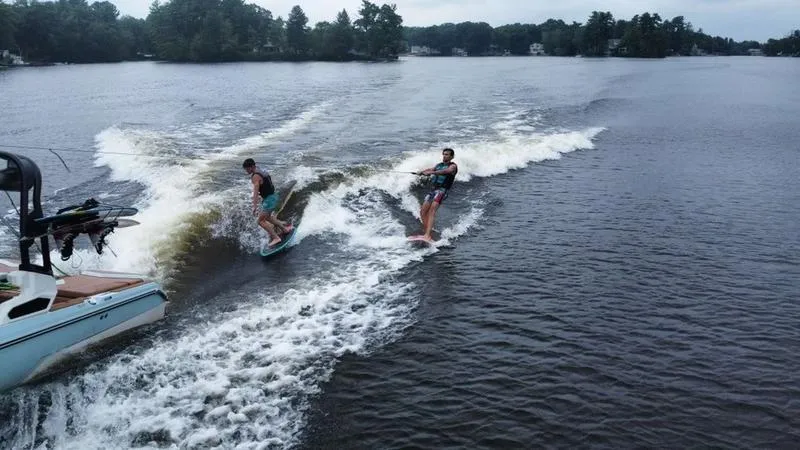 Slide: The Image of 2023 Nautique Super Air Nautique GS20 towing two wakeboarders on a lake. - 5