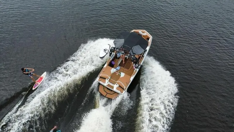 Slide: The Image of 2023 Nautique Super Air Nautique GS20 towing a wakeboarder on a lake. - 6