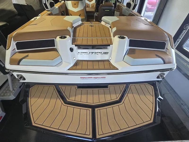 Slide: The Image of 2023 Nautique Super Air Nautique GS20 boat interior with tan seating and deck. - 8