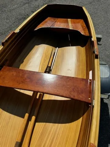 Slide: The Image of 2024 Custom Lawton Tender boat with wooden interior and oars, viewed from above. - 3