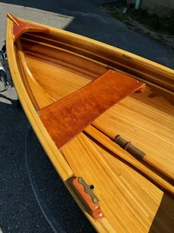 Slide: The Image of 2024 Custom Lawton Tender boat with wooden interior and sleek design. - 4