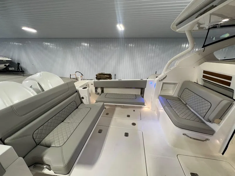 Slide: The Image of 2026 Pursuit DC 365 Dual Console boat interior with luxurious seating and modern design. - 13