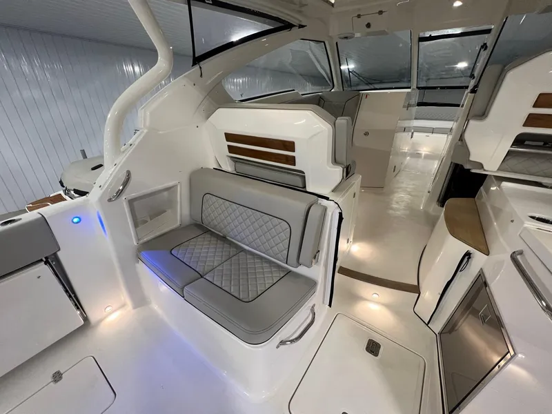 Slide: The Image of 2026 Pursuit DC 365 Dual Console interior with modern seating and sleek design. - 14