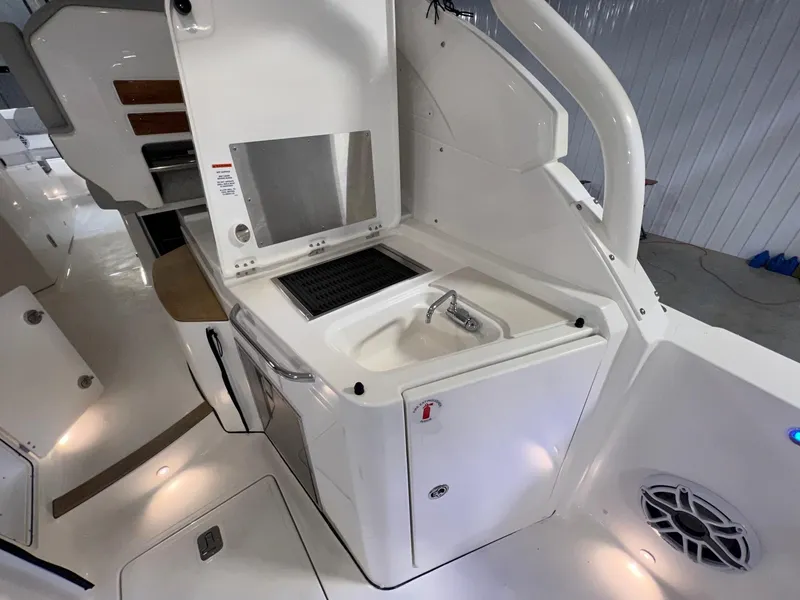 Slide: The Image of 2026 Pursuit DC 365 Dual Console boat interior with sink and storage area. - 19