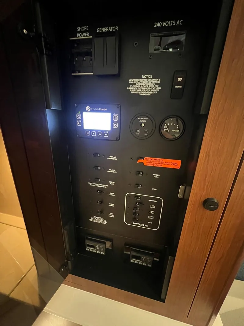 Slide: The Image of Electrical panel of 2026 Pursuit DC 365 Dual Console boat, featuring various controls and switches. - 21