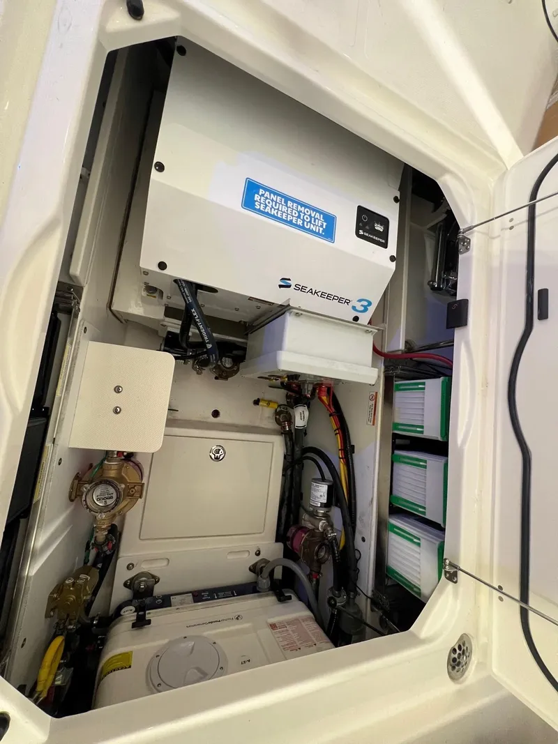 Slide: The Image of Engine compartment of a 2026 Pursuit DC 365 Dual Console boat, featuring Seakeeper 3 system. - 22