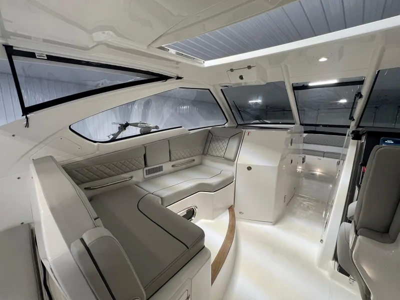 Slide: The Image of 2026 Pursuit DC 365 Dual Console interior with sleek seating and modern design. - 26