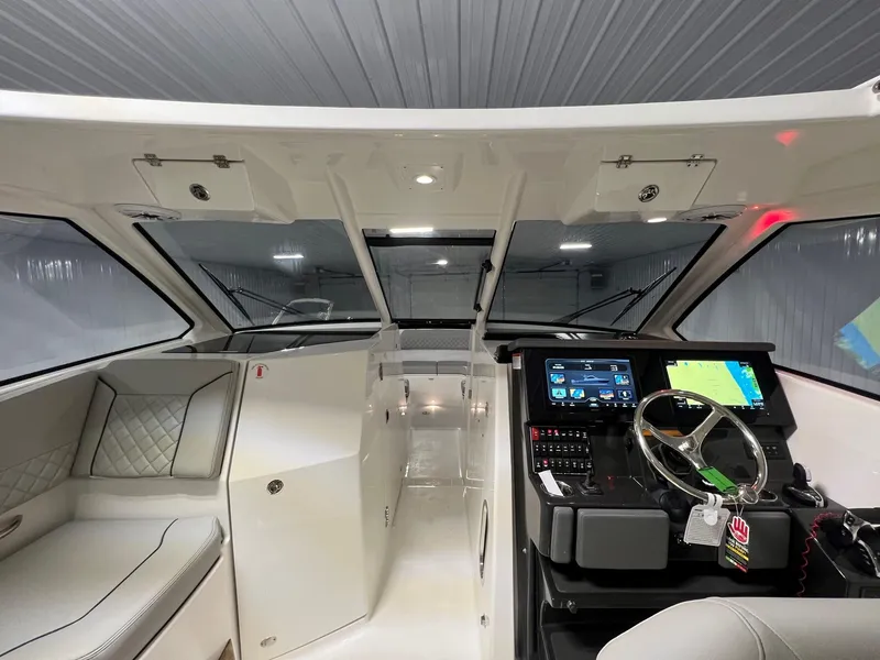 Slide: The Image of 2026 Pursuit DC 365 Dual Console interior with modern dashboard and seating. - 27