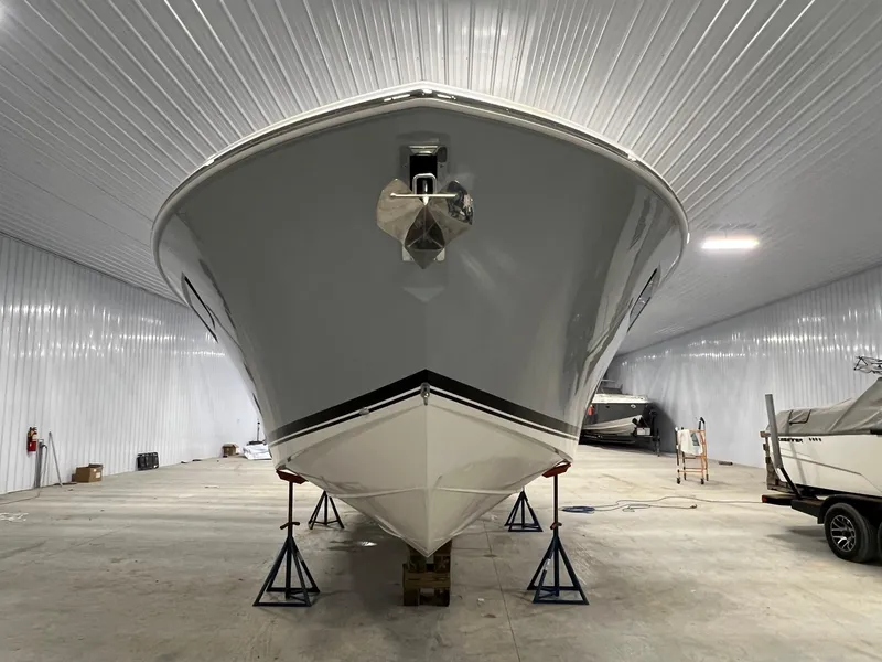 Slide: The Image of 2026 Pursuit DC 365 Dual Console boat in storage, front view. - 6