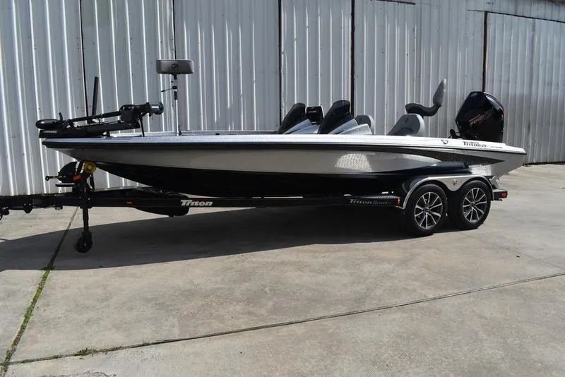 The Image of 2025 Triton 21XP Patriot boat on trailer, parked outdoors. - 0