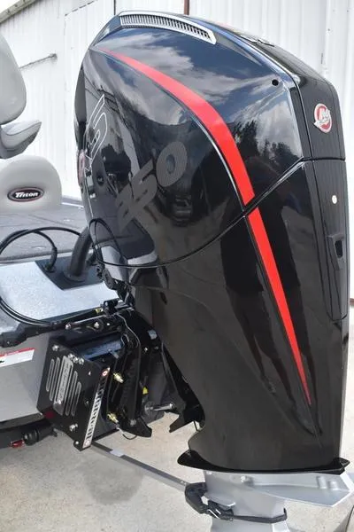 Slide: The Image of 2025 Triton 21XP Patriot trailer hitch with safety strap and tail light. - 10